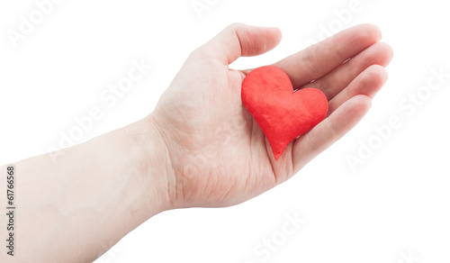 Photo: Red cloth heart in hand. Selective focus on heart. Red cloth heart in hand. Selective focus on heart.