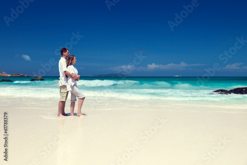 Photo: man and woman romantic couple on tropical beach man and woman romantic couple on tropical beach