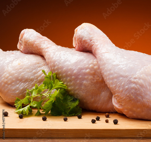 Photo: Raw chicken legs on cutting board Raw chicken legs on cutting board