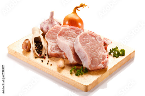 Photo: Raw pork on cutting board and vegetables Raw pork on cutting board and vegetables