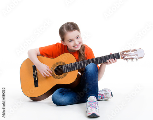 Photo: Cute girl plays on the acoustic guitar. Cute girl plays on the acoustic guitar.