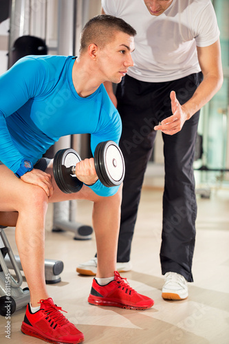 Photo: man exercising under supervision trainer man exercising under supervision trainer