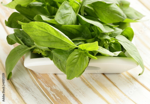 Photo: organic fresh green basil on a wooden table organic fresh green basil on a wooden table