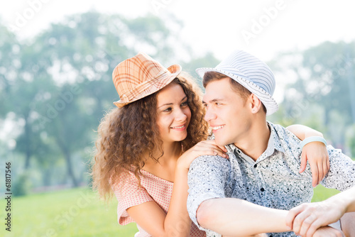 Photo: couple lying on the grass in the summer park couple lying on the grass in the summer park