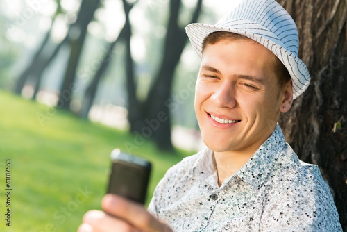 Photo: young man with a cell phone young man with a cell phone