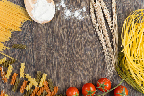 Photo: pasta, tomatoes and flour on the spoon pasta, tomatoes and flour on the spoon