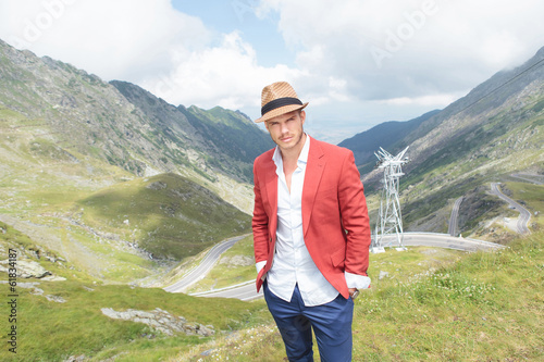 Photo: young man looks at you from mountains young man looks at you from mountains