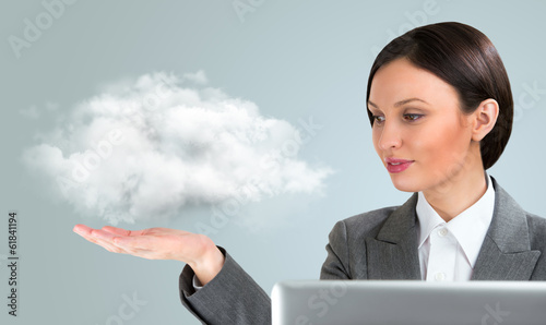 Photo: Business woman using cloud services Business woman using cloud services