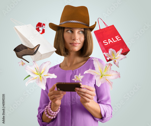 Photo: Woman shopping online using her smartphone Woman shopping online using her smartphone