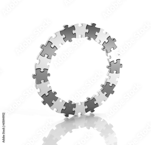 Photo: Black and white puzzle pieces in a circle isolated Black and white puzzle pieces in a circle isolated