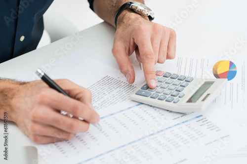 Photo: Man Calculating Finance Man Calculating Finance