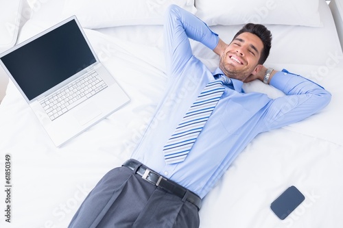 Photo: Happy businessman lying on his bed Happy businessman lying on his bed