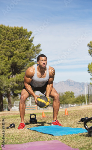 Photo: Male Exercising with Medicine Ball Male Exercising with Medicine Ball
