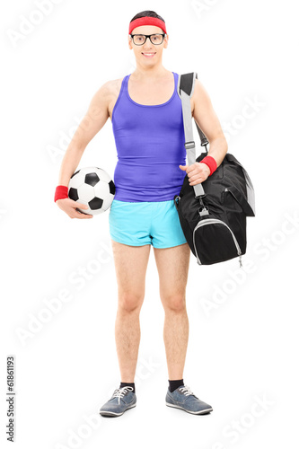 Photo: Young athlete with sports bag holding football Young athlete with sports bag holding football