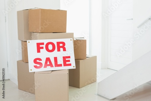 Photo: For sale sign with many cardboard boxes For sale sign with many cardboard boxes