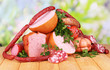 Lot of different sausages on wooden table on natural background Lot of different sausages on wooden table on natural background
