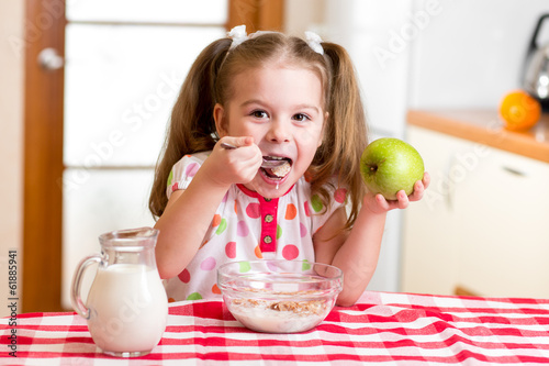Photo: happy kid eating corn flakes with milk happy kid eating corn flakes with milk