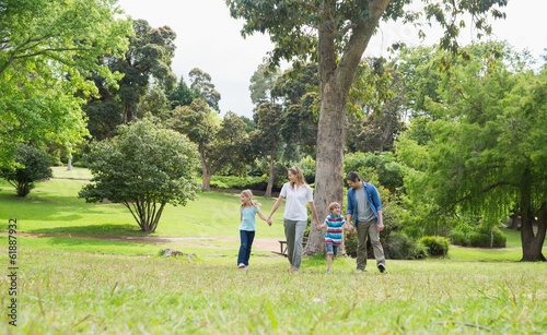 Photo: Parents and kids walking in park Parents and kids walking in park