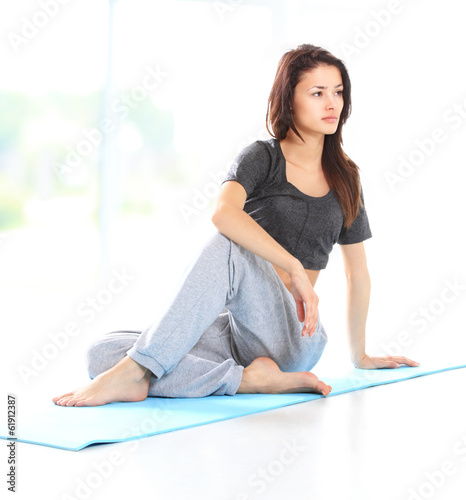 Photo: Beautiful young woman relaxing after doing exercise Beautiful young woman relaxing after doing exercise