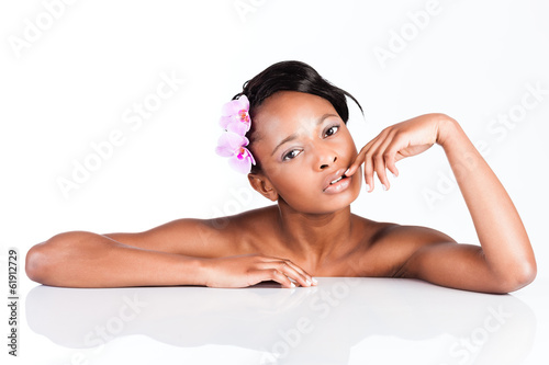 Photo: Beautiful African woman in Studio doing body care Beautiful African woman in Studio doing body care