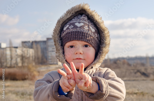 Photo: Cute young boy making V-sign gestures Cute young boy making V-sign gestures