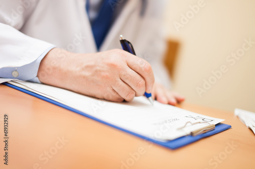 Photo: Doctor writing a prescription Doctor writing a prescription