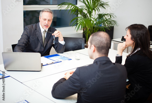 Photo: Man talking to a couple Man talking to a couple