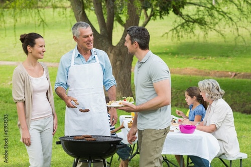 Photo: Extended family with barbecue in park Extended family with barbecue in park