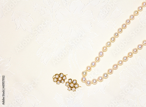 Photo: Elegant pearl necklace,matching earrings on cloth Elegant pearl necklace,matching earrings on cloth