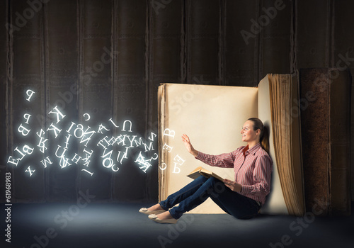 Photo: young woman reading a book young woman reading a book