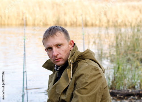 Photo: Middle-aged fisherman fishing at a lake Middle-aged fisherman fishing at a lake
