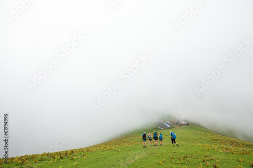 Photo: Young people are hiking in Carpathian mountains in summertime Young people are hiking in Carpathian mountains in summertime