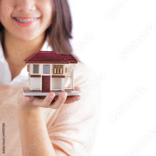 Photo: Woman holding little house Woman holding little house