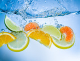 Tropical fruits fall deeply under water with a big splash