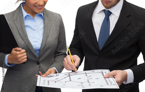 Photo: businesspeople with clipboard, blueprint, helmet businesspeople with clipboard, blueprint, helmet