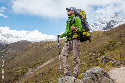 Photo: Hiker posing in Himalayas in front of big mountains Hiker posing in Himalayas in front of big mountains