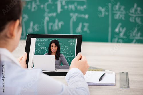 Photo: Woman Having Videochat With Digital Tablet Woman Having Videochat With Digital Tablet