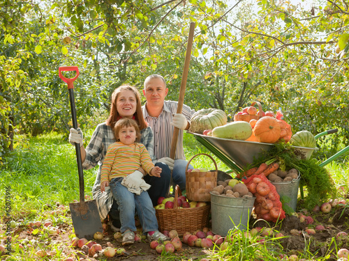 Photo: Happy parents and child with vegetables Happy parents and child with vegetables
