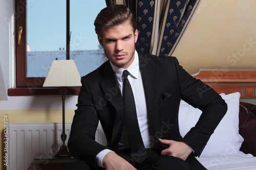 Photo: young business man sits by the window young business man sits by the window