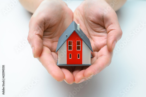 Photo: house in human hands house in human hands
