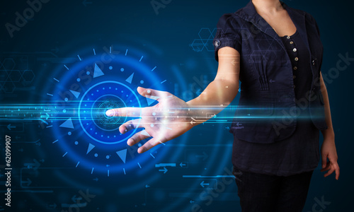 Photo: Young tech woman pressing high technology control panel screen c Young tech woman pressing high technology control panel screen c