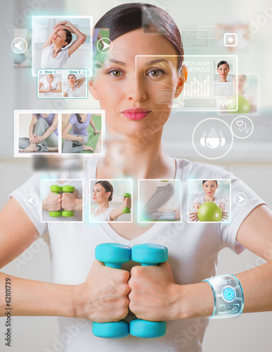 Photo: Woman doing exercise with dumbbells wearing smart wearable devic Woman doing exercise with dumbbells wearing smart wearable devic