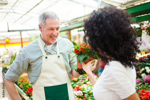 Photo: Florist selling flowers to a customer Florist selling flowers to a customer