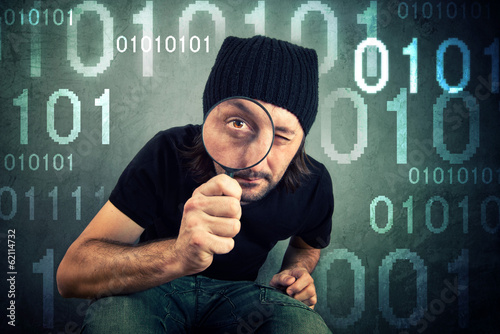 Photo: Man looking through magnifying glass Man looking through magnifying glass