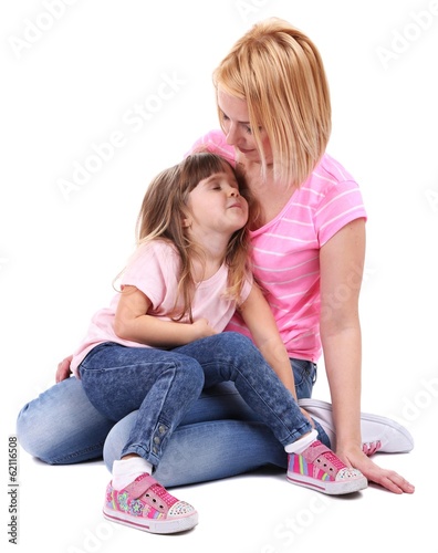 Photo: Pretty little girl with mother isolated on white Pretty little girl with mother isolated on white