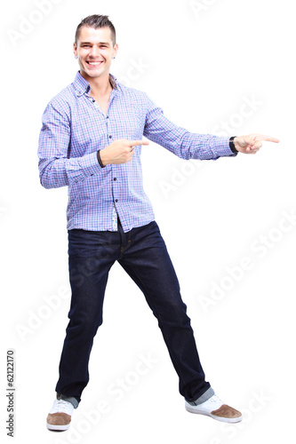 Photo: Happy smiling young man presenting and showing your text Happy smiling young man presenting and showing your text
