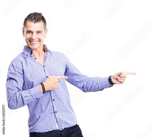 Photo: Happy smiling young man presenting and showing your text Happy smiling young man presenting and showing your text
