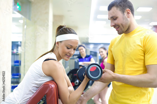 Photo: woman with instructor in gym woman with instructor in gym