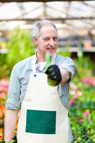 Photo: Green house employee thumbs up Green house employee thumbs up