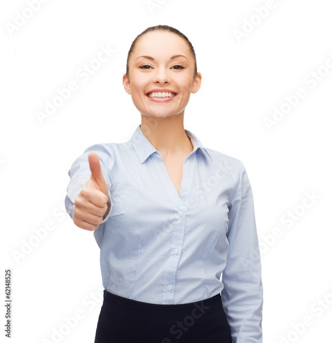Photo: young smiling businesswoman showing thumbs up young smiling businesswoman showing thumbs up